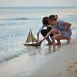 99px.ru аватар Парень с девушкой пускают в море маленький парусник