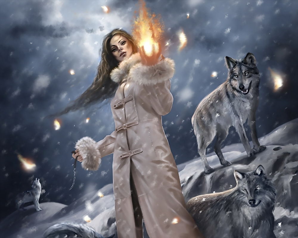 Обои для рабочего стола Магия огня. Девушка стоит посреди стаи волков, которые завороженно смотрят на светящийся в её руках огненный шар.