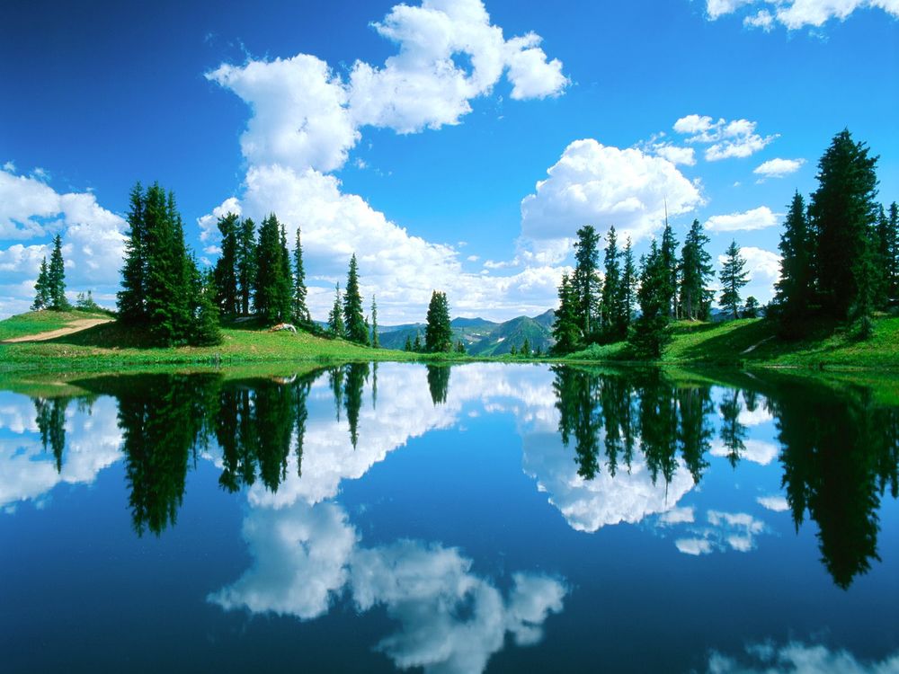Обои для рабочего стола Красивый вид на озеро, отражающем в себе облака, проплывающие по небу