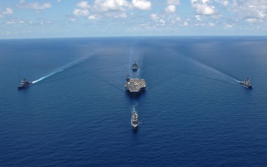 Обои на рабочий стол Авианосец и военные катера на рейде