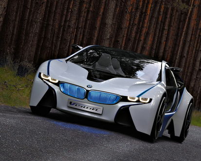 Обои на рабочий стол BMW Vision ED с неоновой подсветкой едет по дороге возле леса