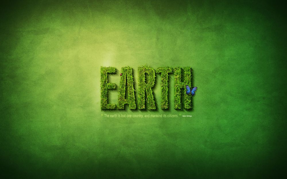 Обои для рабочего стола Земля / Earth - надпись из зеленой травы, на которой сидит бабочка ('The earth is but one country, and mankind its citizens')