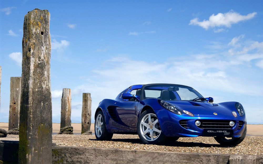 Обои для рабочего стола Lotus Elise S 924 / Лотус Элис С 924 стоит у каменных плит 