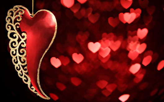 Обои на рабочий стол Декоративное сердечко, наполовину сделанное из позолоченных завитков на фоне мерцания в виде сердечек
