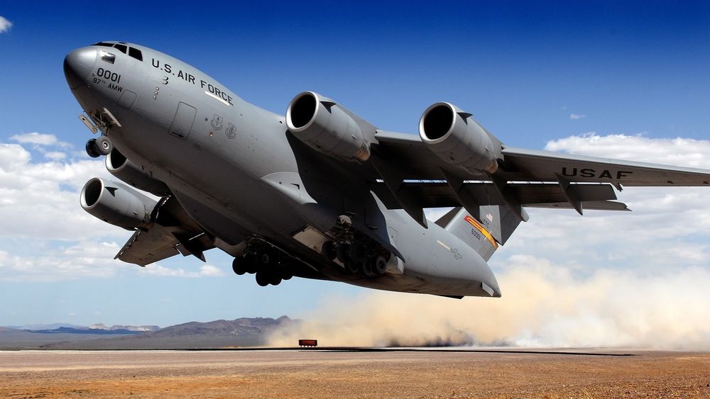 Обои для рабочего стола Военно-транспортный самолет C-17A globemaster (Глоубмастер III ) производства корпорации Макдоннелл-Дуглас, состоящий на вооружении Армии США, производит взлет с грунтовой взлетно-посадочный полосы