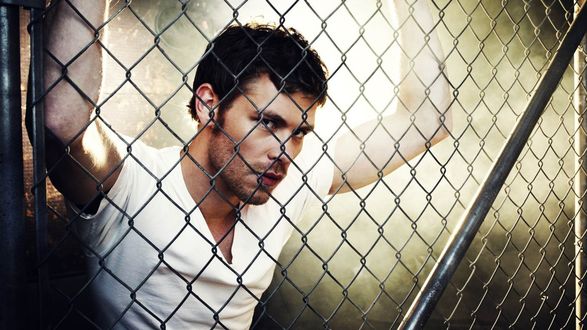 Обои на рабочий стол Актер Джозеф Морган / Joseph Morgan оперся о решетку