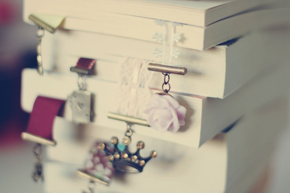 Обои для рабочего стола Стопка книг с закладками в виде короны и розы