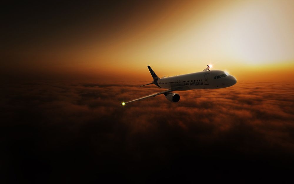 Обои для рабочего стола Пассажирский самолет AIRBUS A320 летит над облаками на фоне заката
