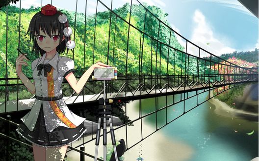 Обои на рабочий стол Aya Shameimaru / Ая Шамеймару из серии игр Тохо / Touhou Project стоит у моста рядом со штативом, держа в одной руке ручку, а другую положив на камеру