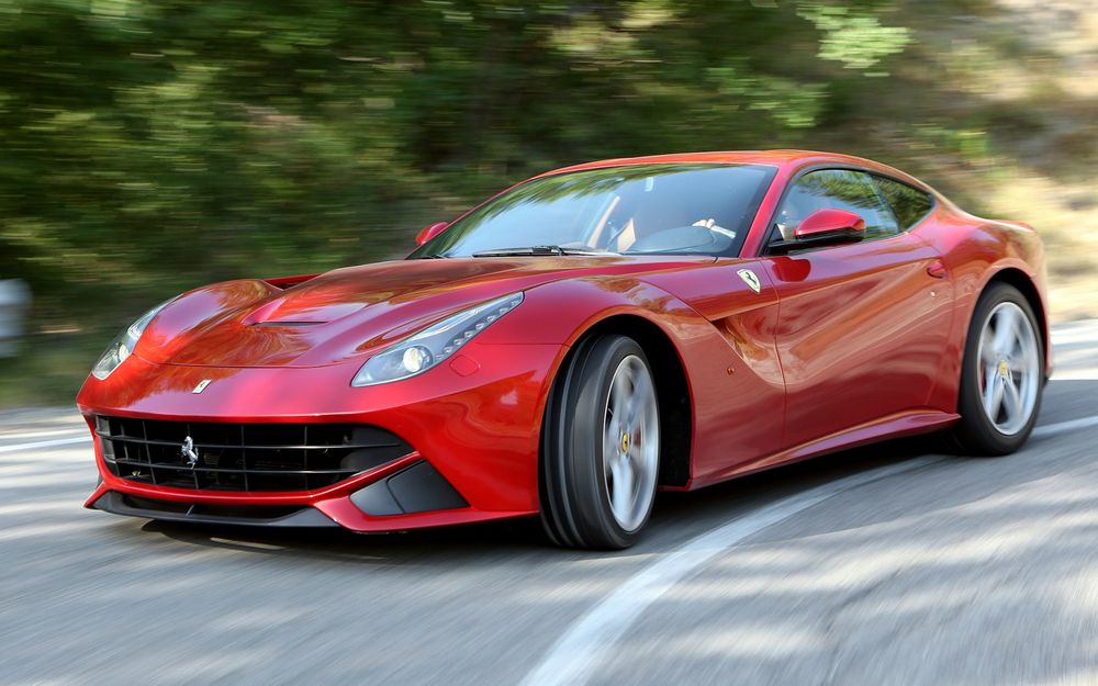 Обои для рабочего стола Красный автомобиль Ferrari F12 berlinetta / Феррари Ф12 мчится по дороге