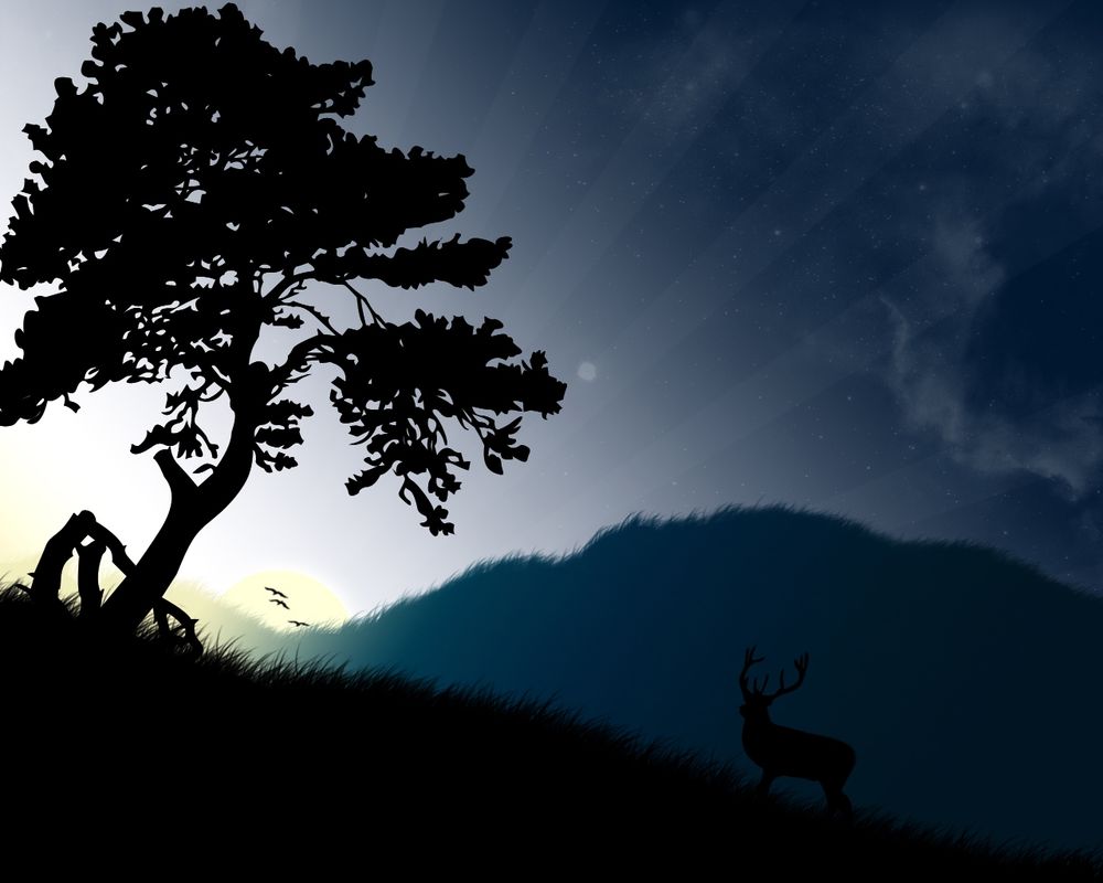 Обои для рабочего стола Олень на рассвете около дерева, на фоне гор и неба