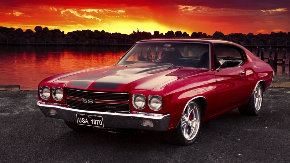 Обои для рабочего стола Автомобиль Chevrolet Chevelle / Шевроле Чевелле вишневого цвета на фоне заката и озера