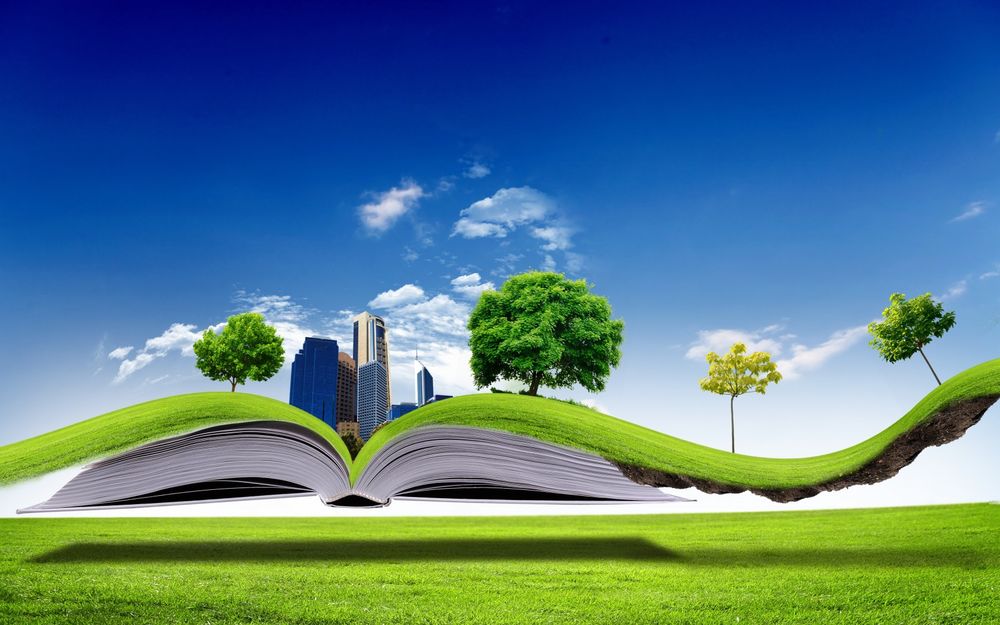 Обои для рабочего стола Раскрытая книга, на которой стоит город, растут деревья