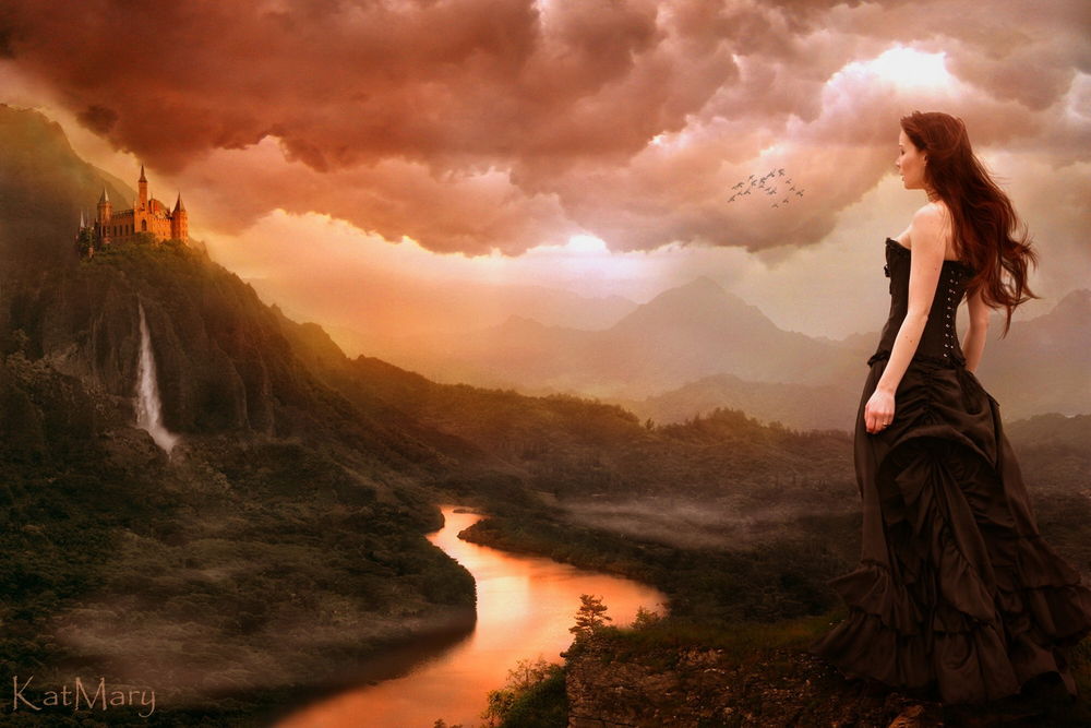 Обои для рабочего стола Девушка-шатенка в длинном темном платье, стоящая на берегу ручья, смотрит на замок, расположенный на высокой горе на фоне пасмурного неба и парящих птиц