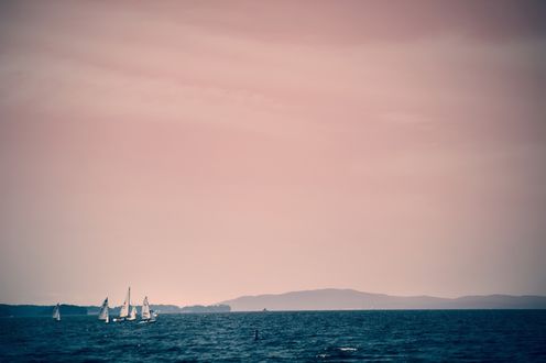 Обои на рабочий стол Вечернее море с плавающими лодками