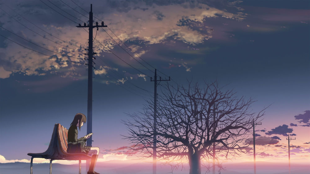 Обои для рабочего стола Девушка читает книгу, сидя на скамейке на фоне заката