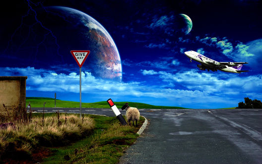 Обои на рабочий стол Дорожный знак с надписью Give Way / Уступи дорогу, стоящий на зеленой обочине асфальтовой дороги, с находящейся недалеко от знака овцой, пощипывающей травку, на фоне голубого неба с небольшой облачностью, летящего пассажирского самолета, появившихся в небе планет и сверкающих молний