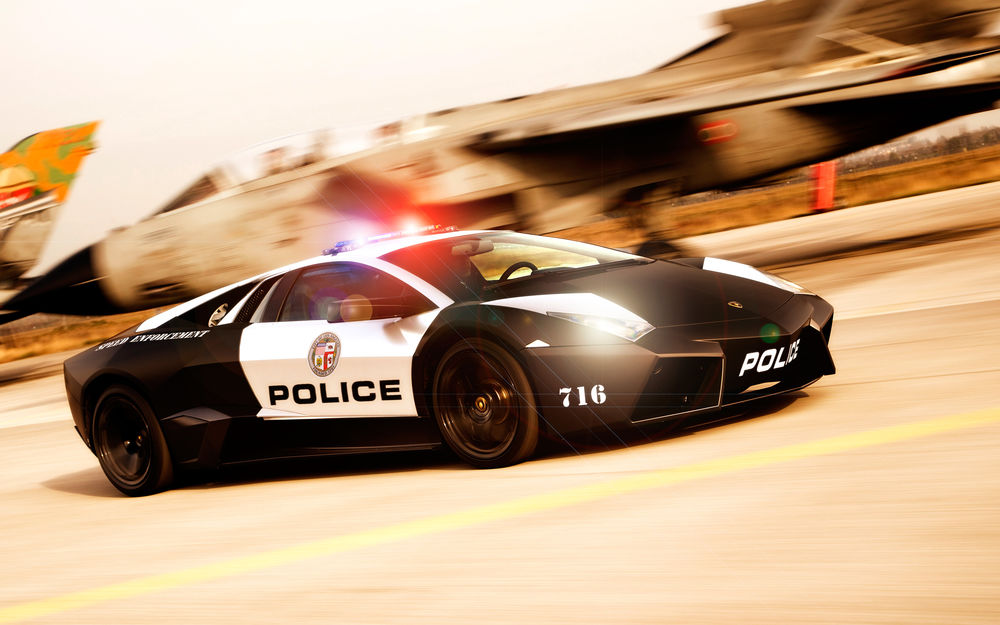 Обои для рабочего стола Полицейский Ламборгини / Lamborghini проносится мимо самолета, включив мигалки
