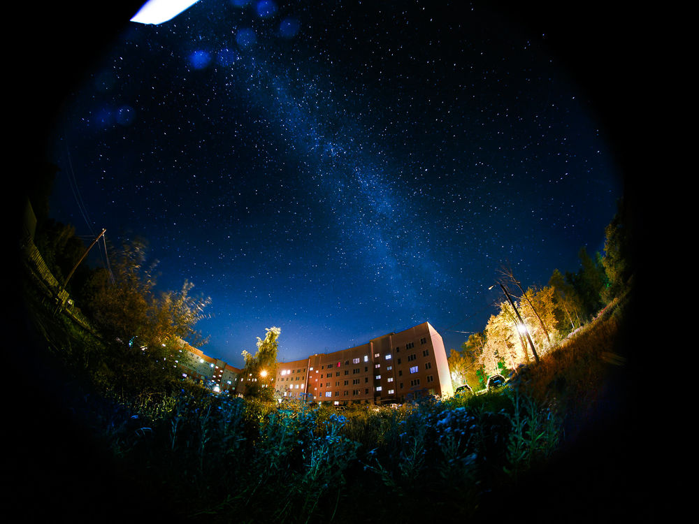 Обои для рабочего стола Городская окраина на фоне ночного, звездного неба и красивого Млечного Пути, фотография выполнена при помощи широкоугольного объектива фотографом Сергеем Зиминым
