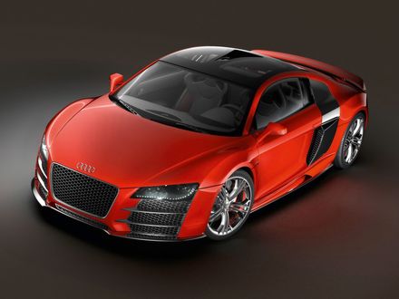 Обои на рабочий стол Легковой автомобиль марки Audi R 8 оранжевого цвета, стоит на площадке