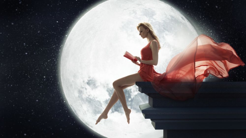 Обои для рабочего стола Девушка сидит в развевающемся красном платье с книгой на фоне луны и звездного неба