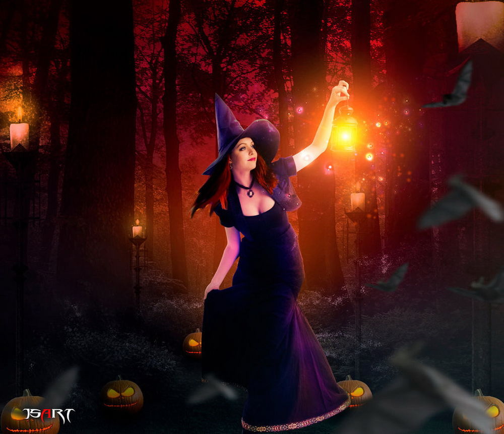 Обои для рабочего стола Рыжеволосая девушка-колдунья в широкополой, островерхой шляпе, стоящая в ночном лесу в окружении горящих свечей с ярко светящимся, магическим фонарем в руке, автор jspanda