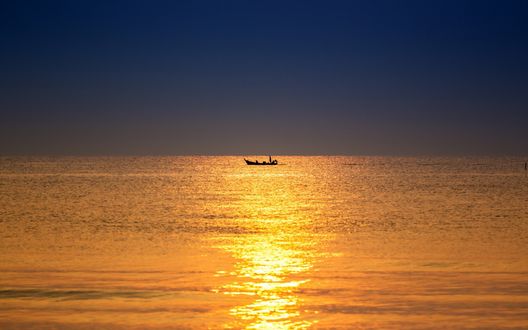 Обои на рабочий стол Одинокая рыбачья лодка на морском горизонте