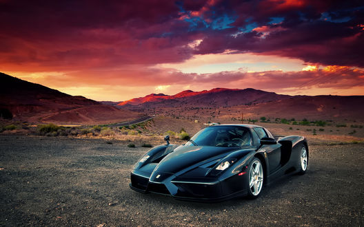 Обои на рабочий стол Ferrari на фоне гор и багрового заката