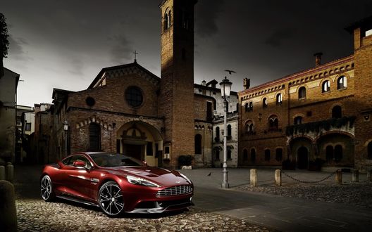 Обои на рабочий стол Aston Martin Vanquish бордовый самый красивый автомобиль в Германии во дворе монастыря