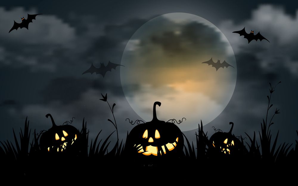 Обои для рабочего стола Злые тыквы Хелоуина лежат на траве, на фоне ночного неба и луны