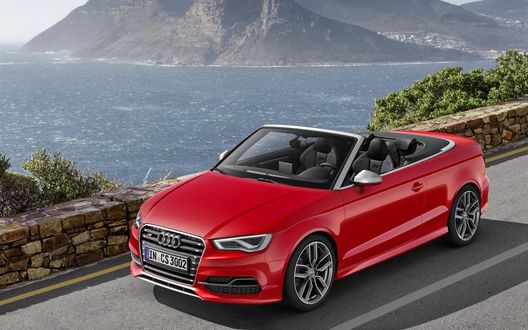 Обои на рабочий стол Audi S3 Cabriolet 2015 года, красного цвета стоит на дороге на фоне моря и горы
