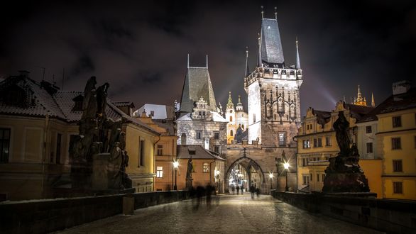 Обои на рабочий стол Старая Прага / Stara Praha, поздний вечер, улица, дома, пешеходы, вдали арка и освещенные башни, после дождя