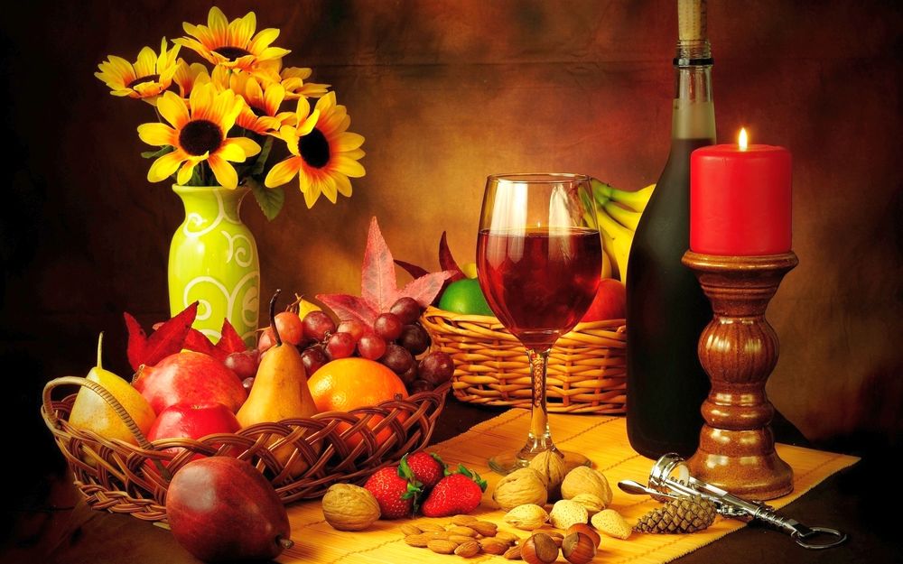 Обои для рабочего стола Фрукты, ягоды, орехи, вино, горящая свеча, бутылка, бокал, корзинки, ваза с букетом подсолнухов, натюрморт
