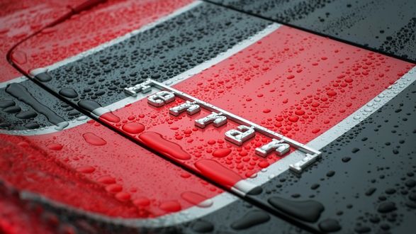 Обои на рабочий стол Логотип знаменитой фирмы Ferrari в каплях воды
