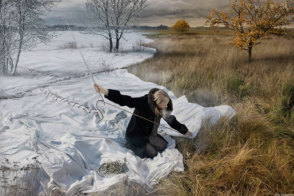 Обои для рабочего стола Девушка сидит на белом полотне и сшивает его большой иглой, укрывает им землю и траву, превращая золотую осень в снежную зиму, by Eric Johansson / Эрик Йоханссон