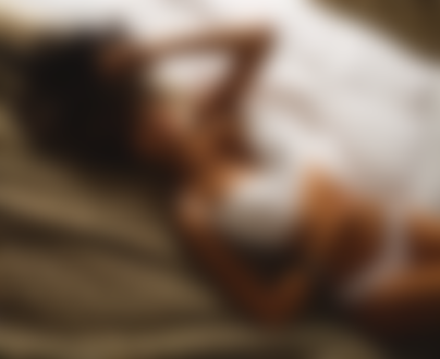 Обои для рабочего стола Улыбающаяся девушка с закрытыми глазами, с тату, в белом нижнем белье лежит на постели, by Aleksandr MAVRIN