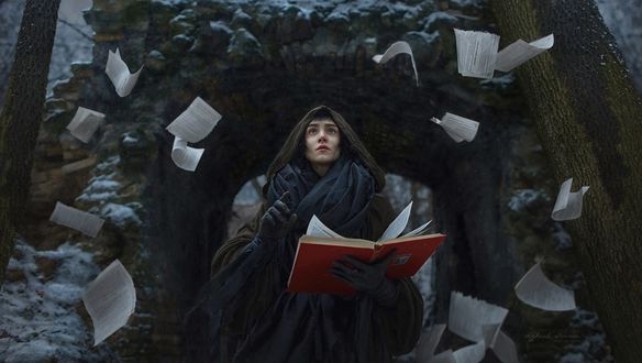 Обои на рабочий стол Девушка в образе колдуньи с книгой в руке и летающих вокруг нее страниц, фотограф Irina Dzhul