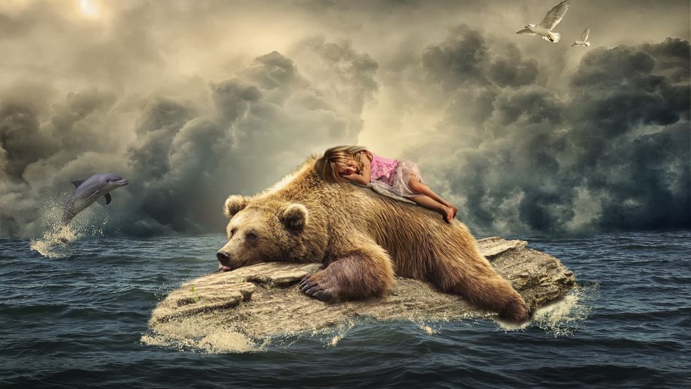 Обои для рабочего стола Девочка спит на медведе, лежащем на камне в океане, дельфин выпрыгивает из воды и летящие чайки на фоне пасмурного неба