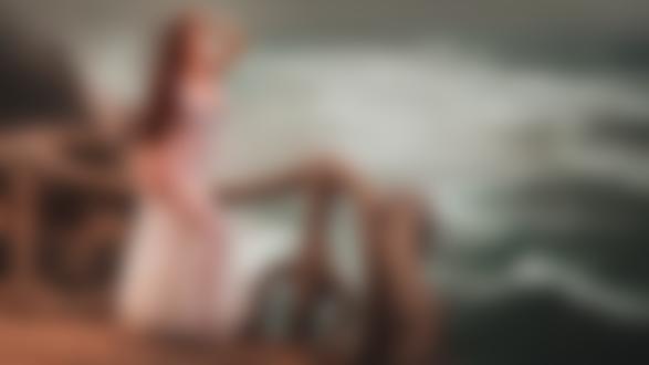 Обои на рабочий стол Симпатичная девушка с длинными волосами, в прозрачном нижнем белье позирует, стоя у ограждения на берегу моря, фотограф Евгений Лоза