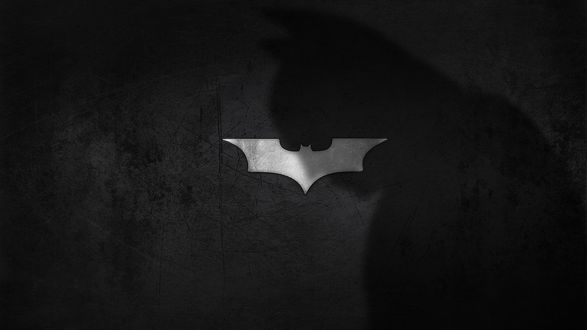 Обои на рабочий стол Тень Бэтмена падающая на его логотип, DC Comics