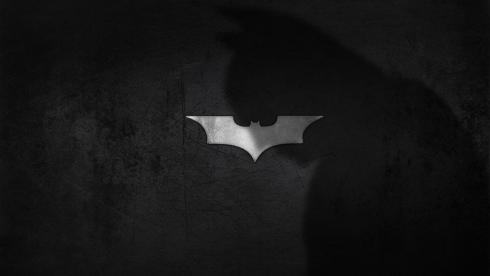 Обои для рабочего стола Тень Бэтмена падающая на его логотип, DC Comics
