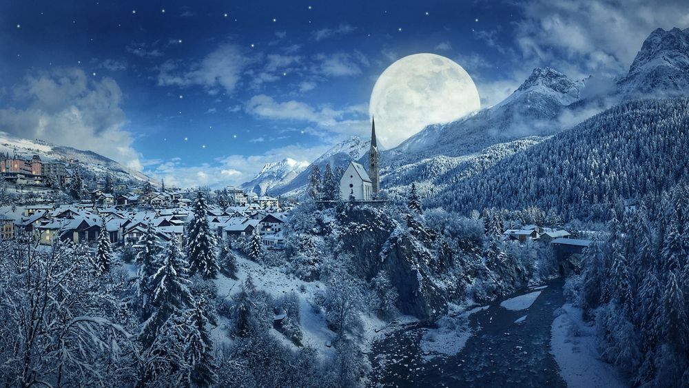 Обои для рабочего стола Городок у подножья гор зимой на фоне огромной луны в небе
