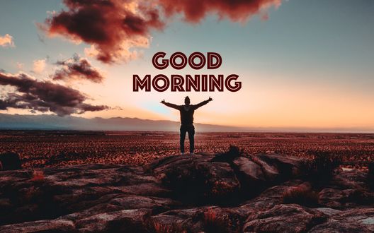 Обои на рабочий стол Мужчина стоит на камнях, подняв и расправив руки (good morning / доброе утро)