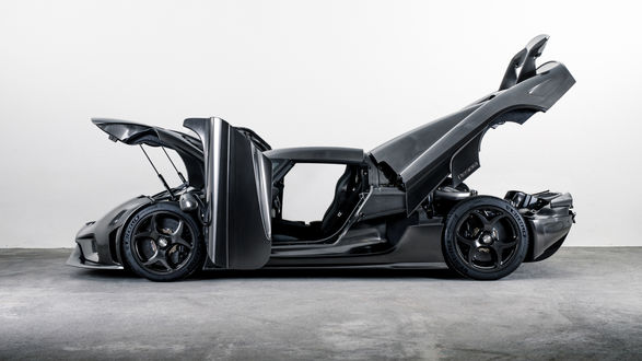 Обои на рабочий стол Полностью открытая Koenigsegg Regera в карбоне стоит на белом фоне