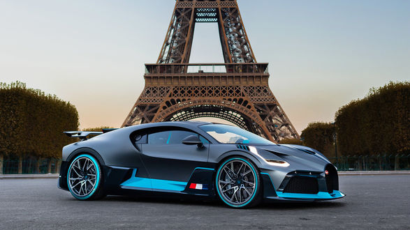 Обои на рабочий стол Новый эксклюзивный гиперкар Bugatti Divo стоит на фоне Эйфелевой башни