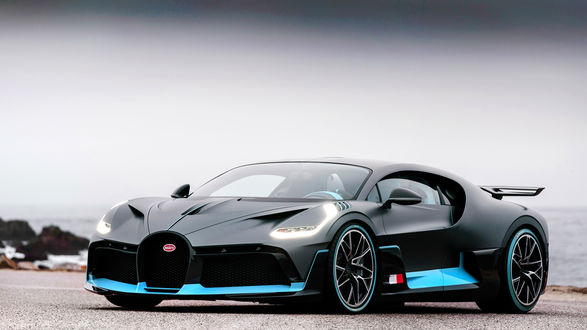 Обои на рабочий стол Французский гиперкар Bugatti Divo стоит на песке на фоне моря