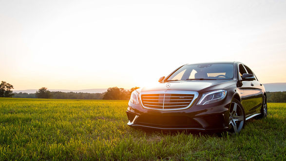 Обои на рабочий стол Mercedes стоит на траве под небом