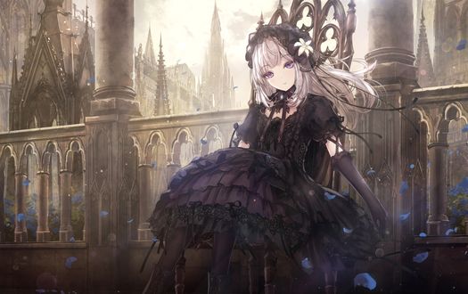Обои на рабочий стол Светловолосая девушка в стиле Gothic Lolita / Готическая Лолита в черной одежде сидит на троне на фоне средневекового замка, вокруг летают синие лепестки