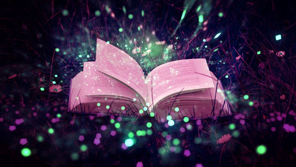 Обои для рабочего стола Открытая книга лежит в траве
