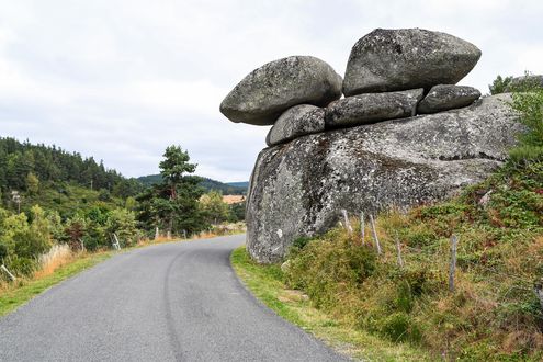 Обои на рабочий стол Дорога на фоне скал с камнями, гор и неба и деревьев, by Christel